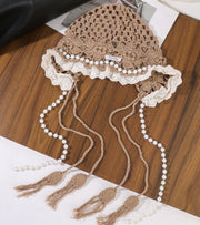 Light brown lace cap with white lace trim and long pearl bead tassels