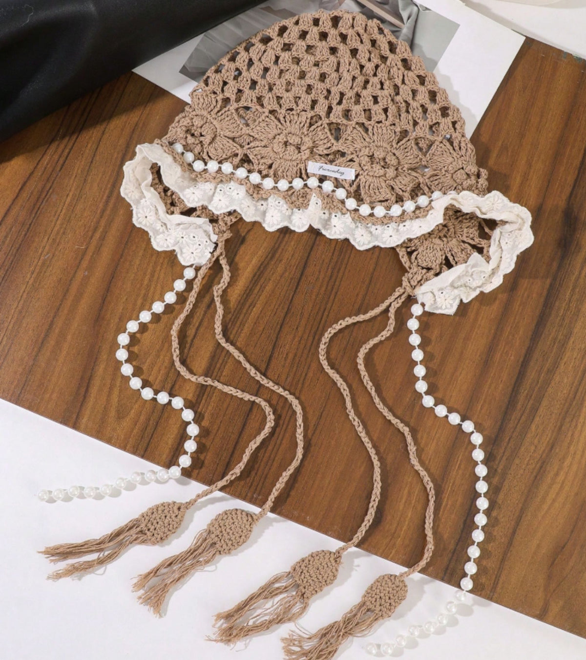 Light brown lace cap with white lace trim and long pearl bead tassels