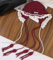 Eternia® red lace cap with white ruffle trim and pearl tassel strings