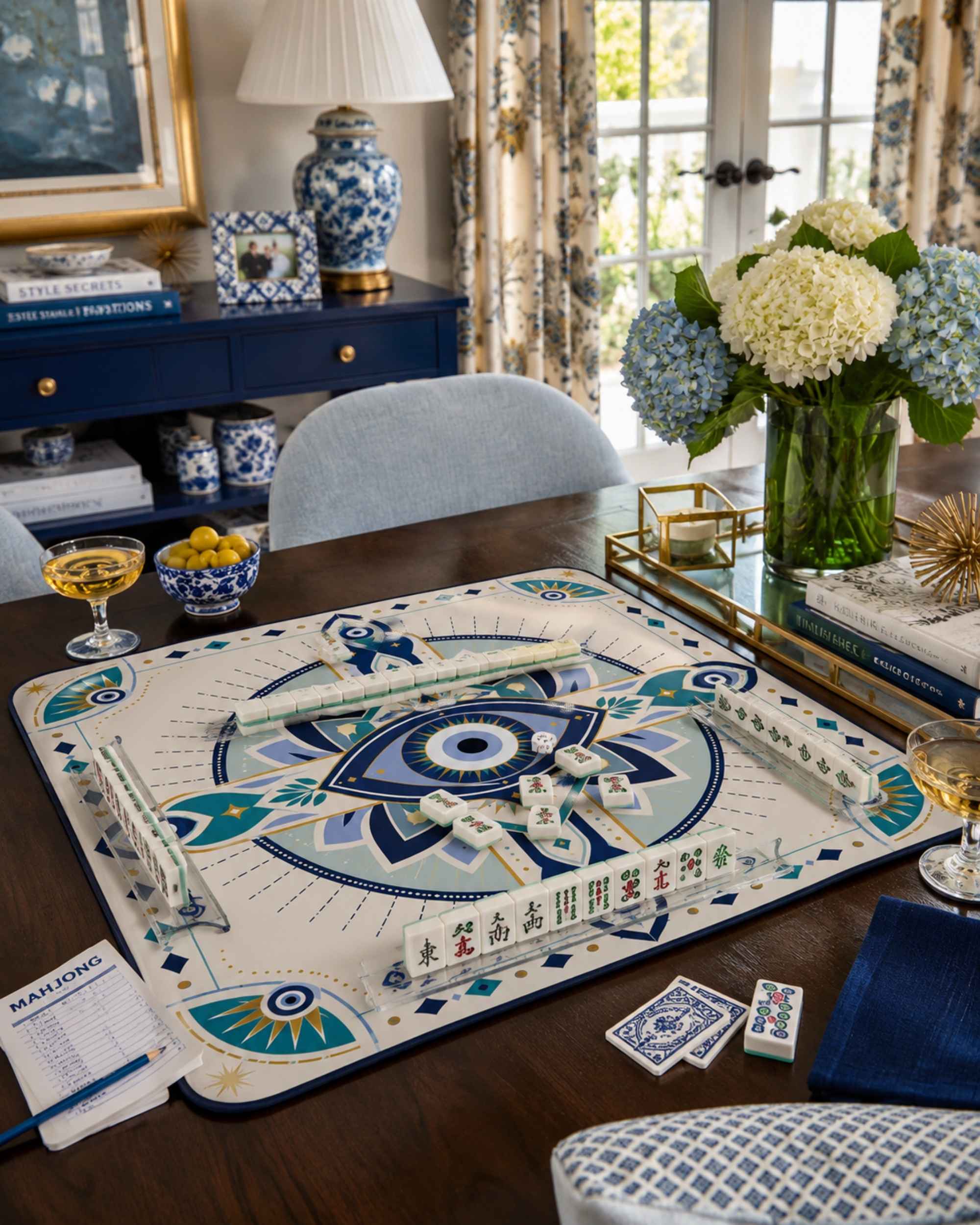 Evil-eye mahjong table mat on tabletop, square blue and cream decorative board-game design