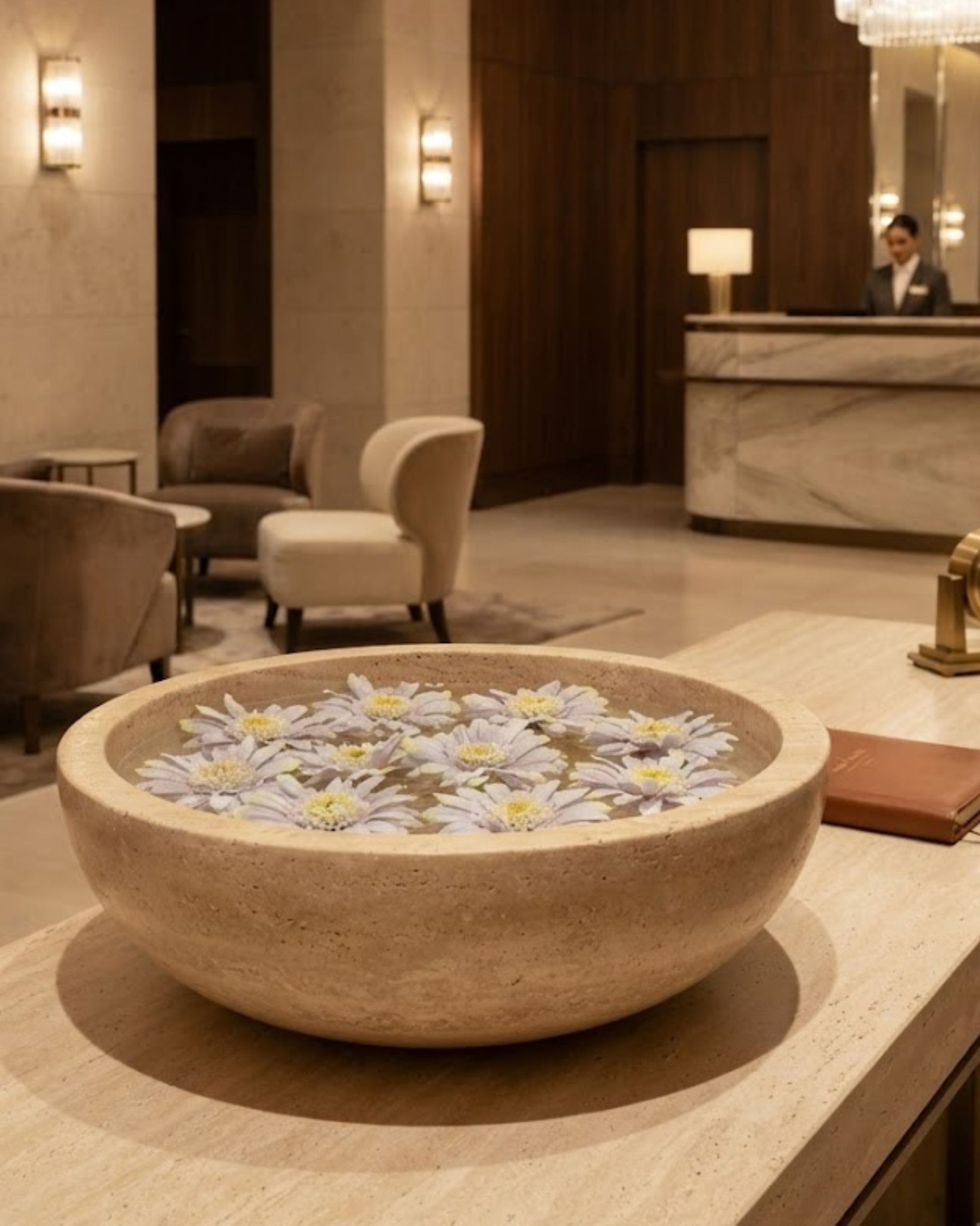 Lavender artificial floating lotus flowers on water in a stone bowl