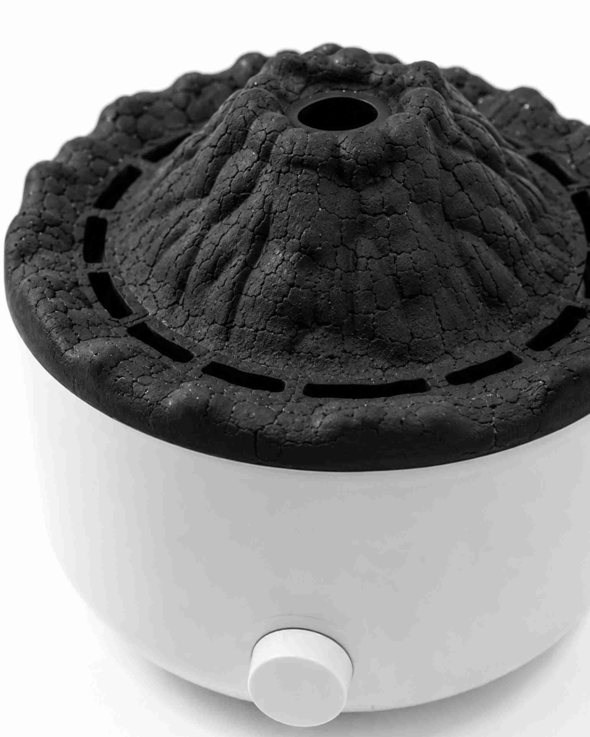 Black volcano-top aroma diffuser on white base with front power button