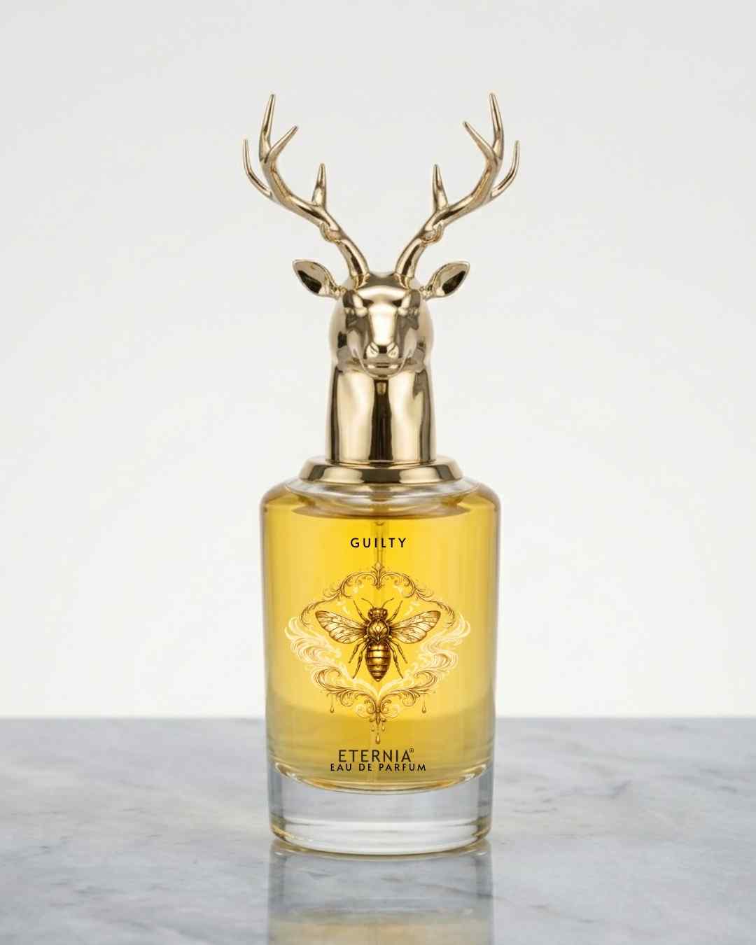 Eternia Guilty eau de parfum bottle with gold deer antler cap, amber glass