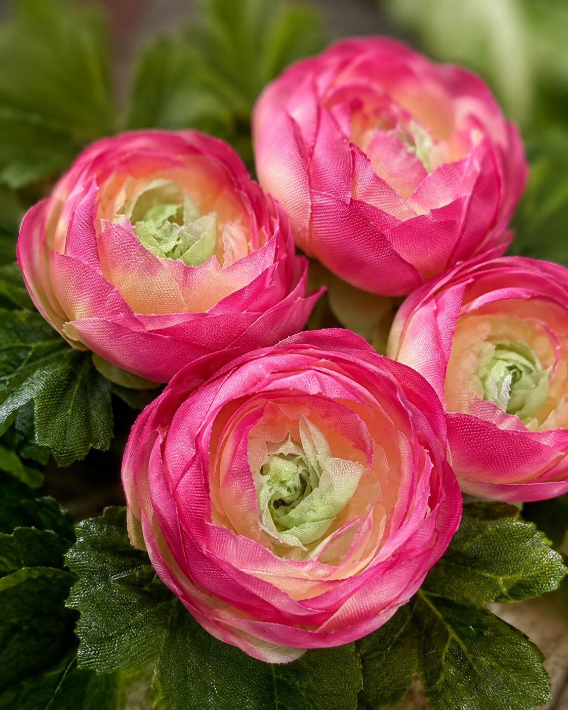Close-up of pink fabric artificial flowers with green leaves for floating decor