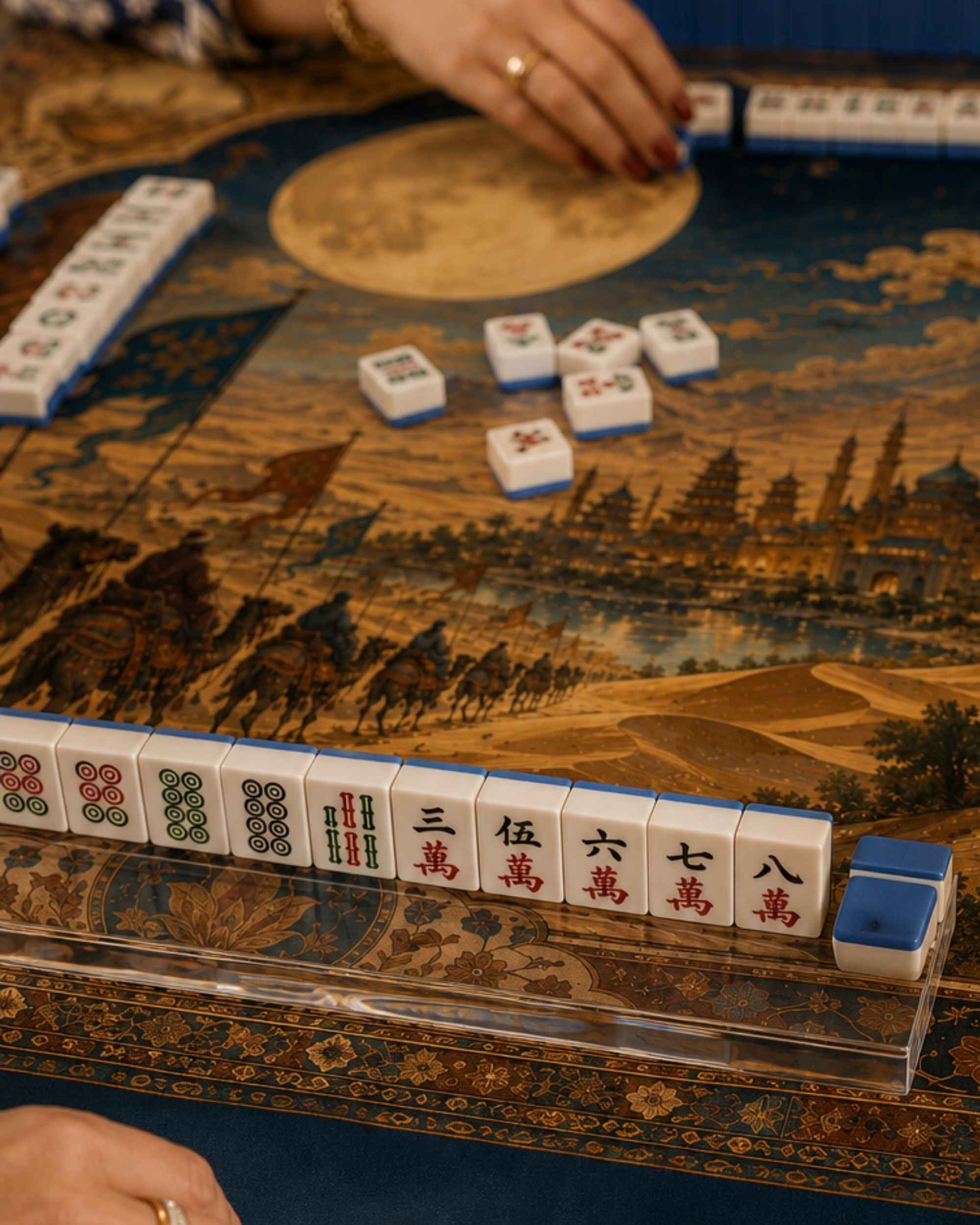 Close-up of square mat with blue, brown, and gold landscape pattern and tiles edge