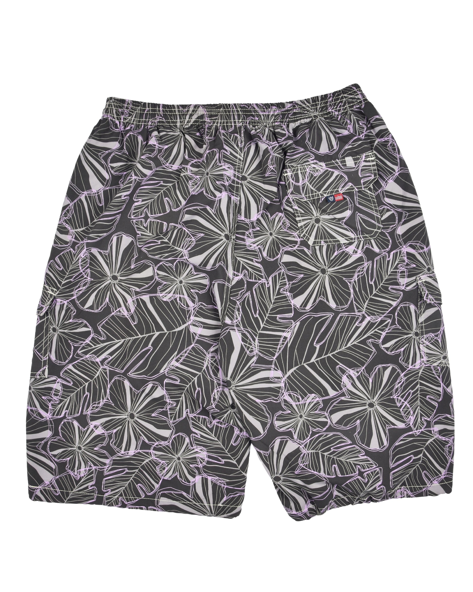 Tropical leaf patterned shorts on a white background