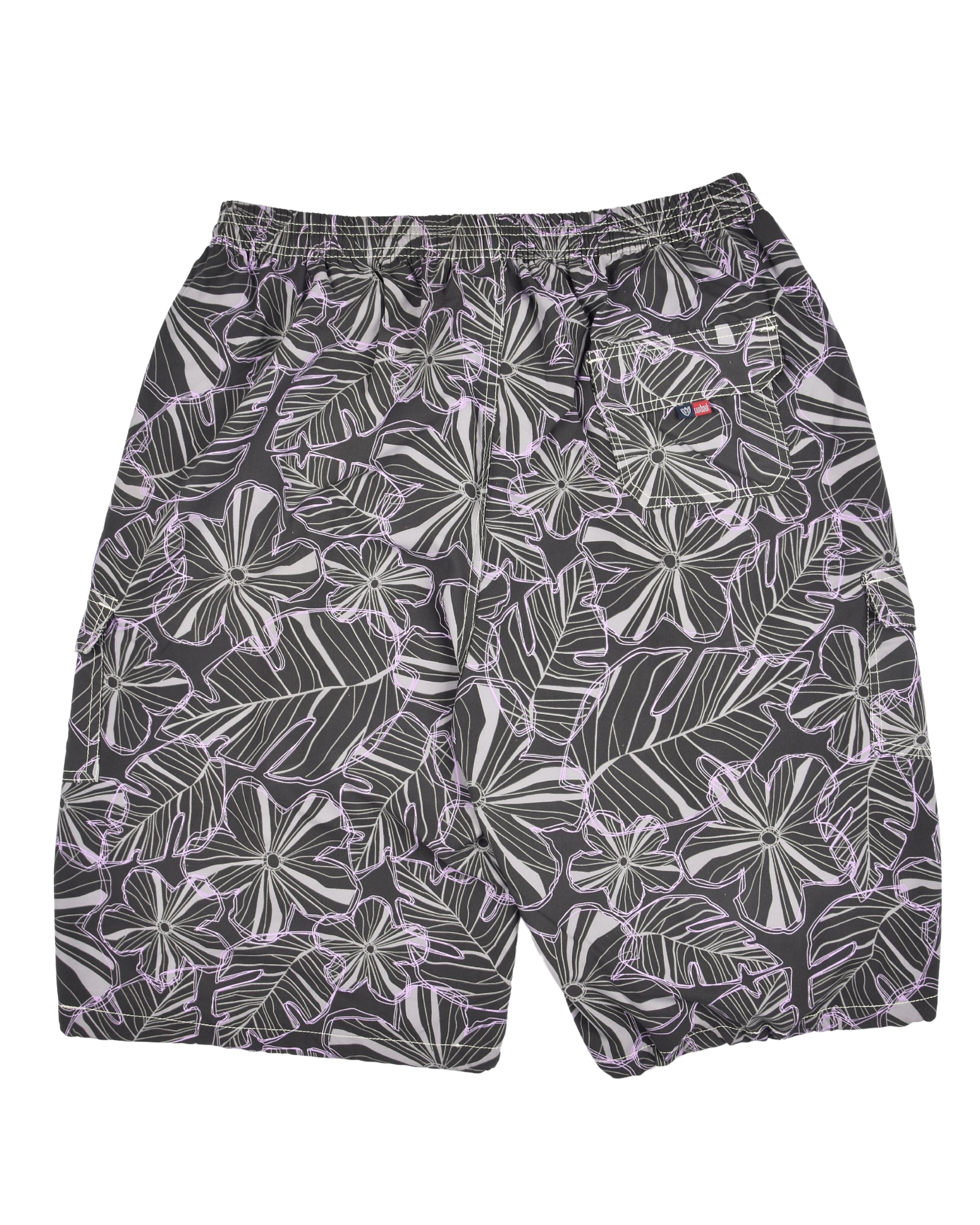 Tropical leaf patterned shorts on a white background