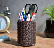 Woven faux leather pen stand, dark brown with desk stationery and scissors inside.