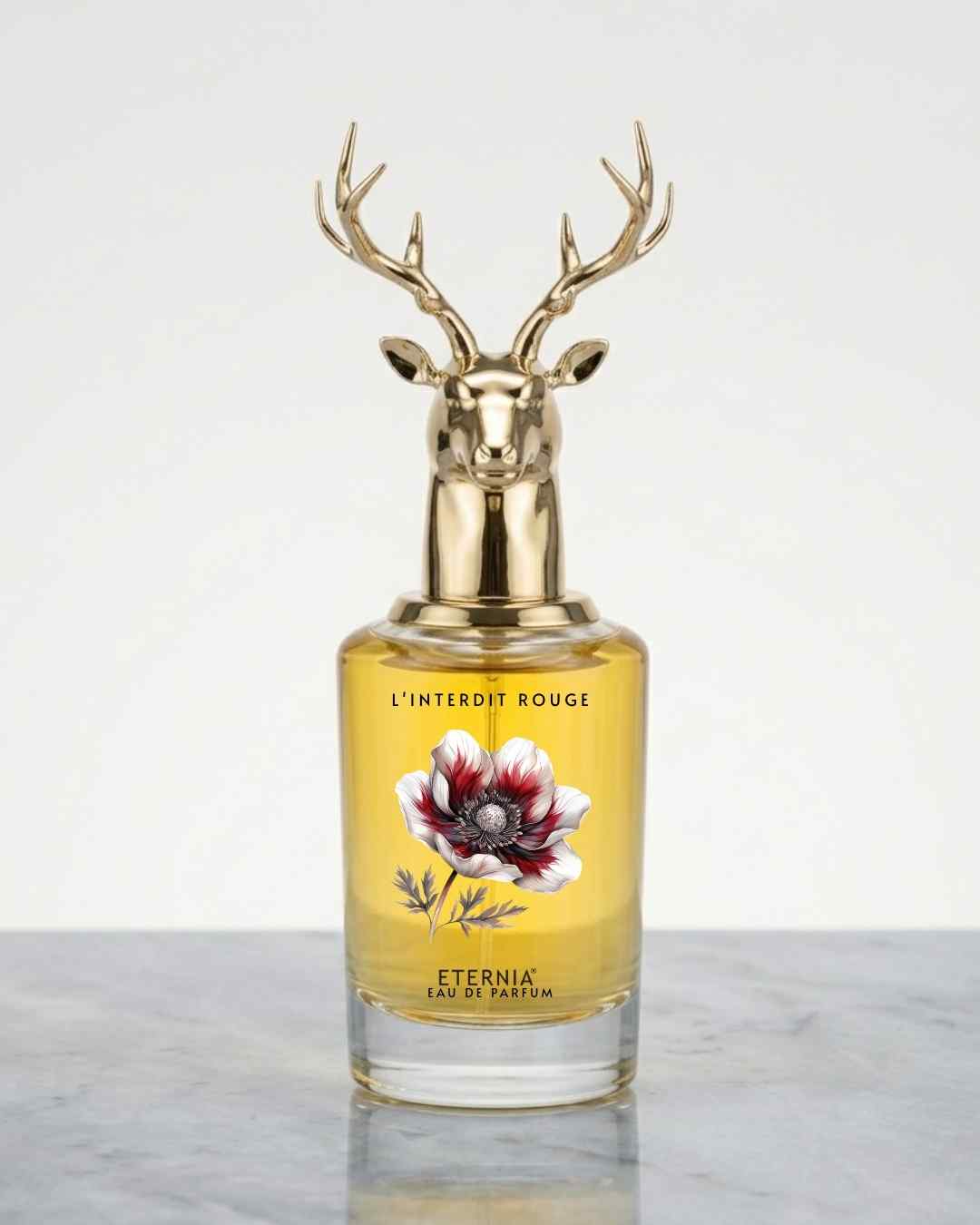 Gold deer-head perfume bottle with antler cap and amber glass, floral label