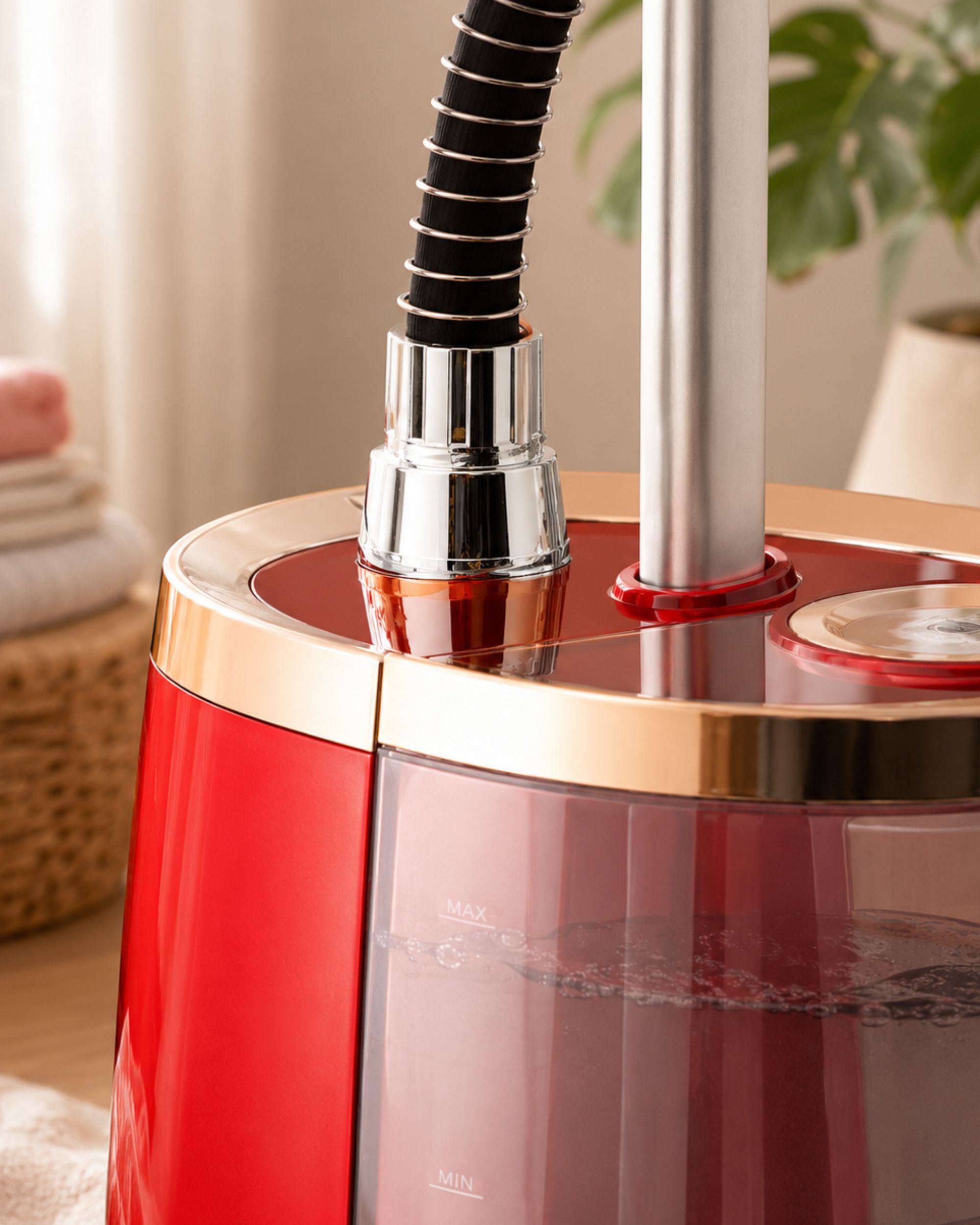 Red and chrome steamer base with vertical metal tubes and steam outlet
