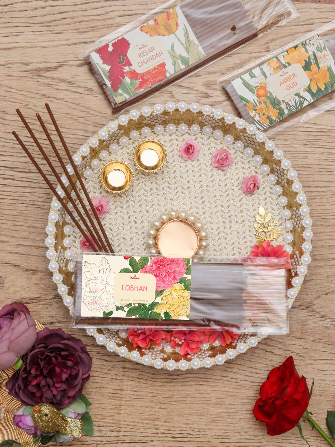 Floral incense agarbatti set on beaded tray with wrapped sticks and small sachet