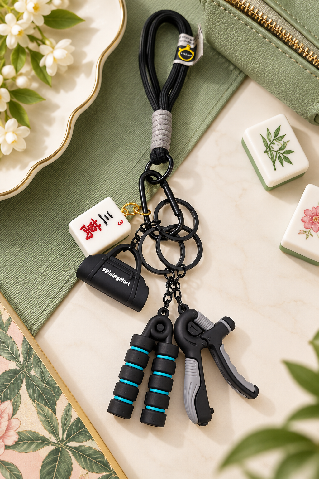 Black mahjong tile keychain with white charm tag and blue cylinder dangle