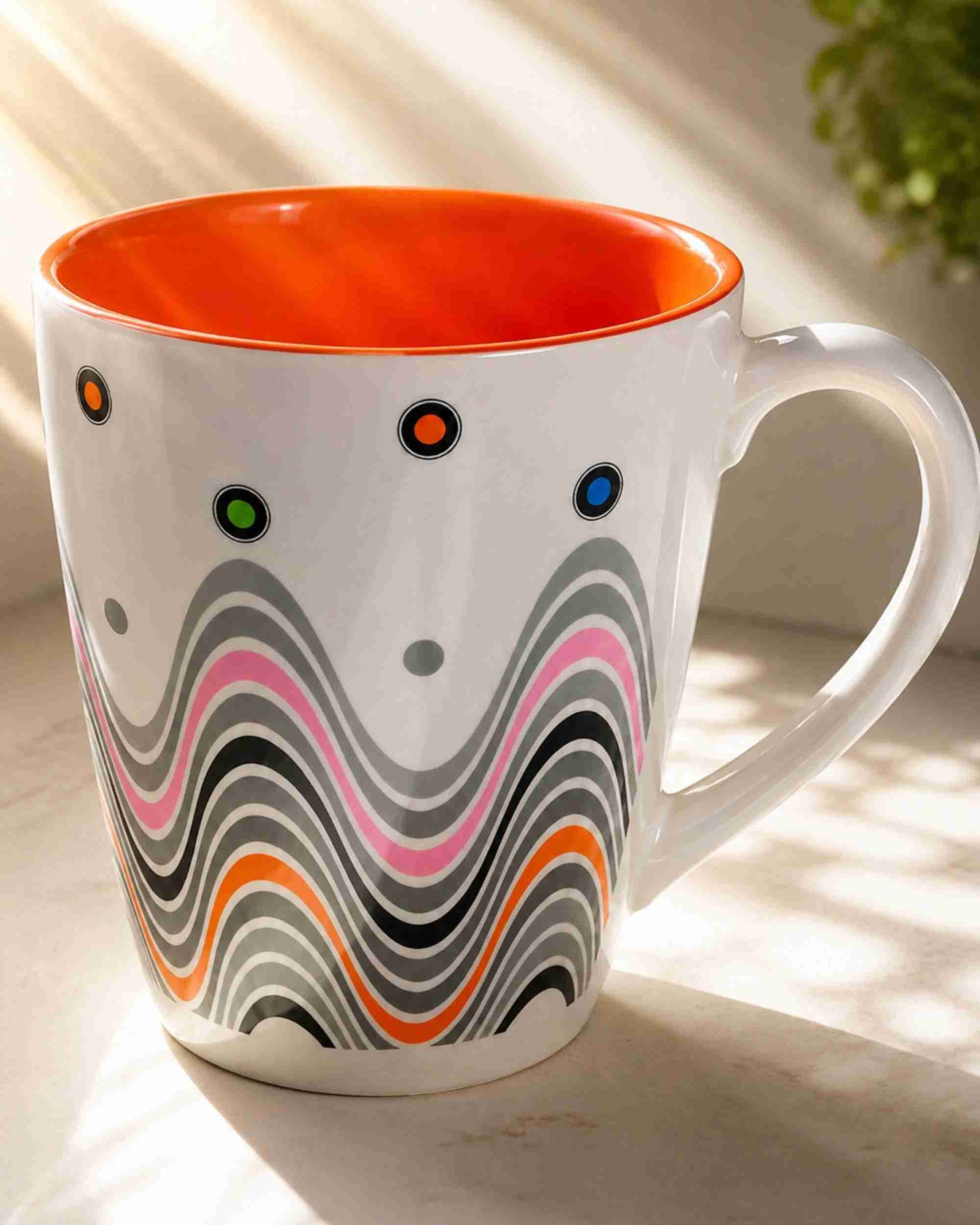 Ceramic coffee mug with orange rim, white body, and multicolor wave pattern