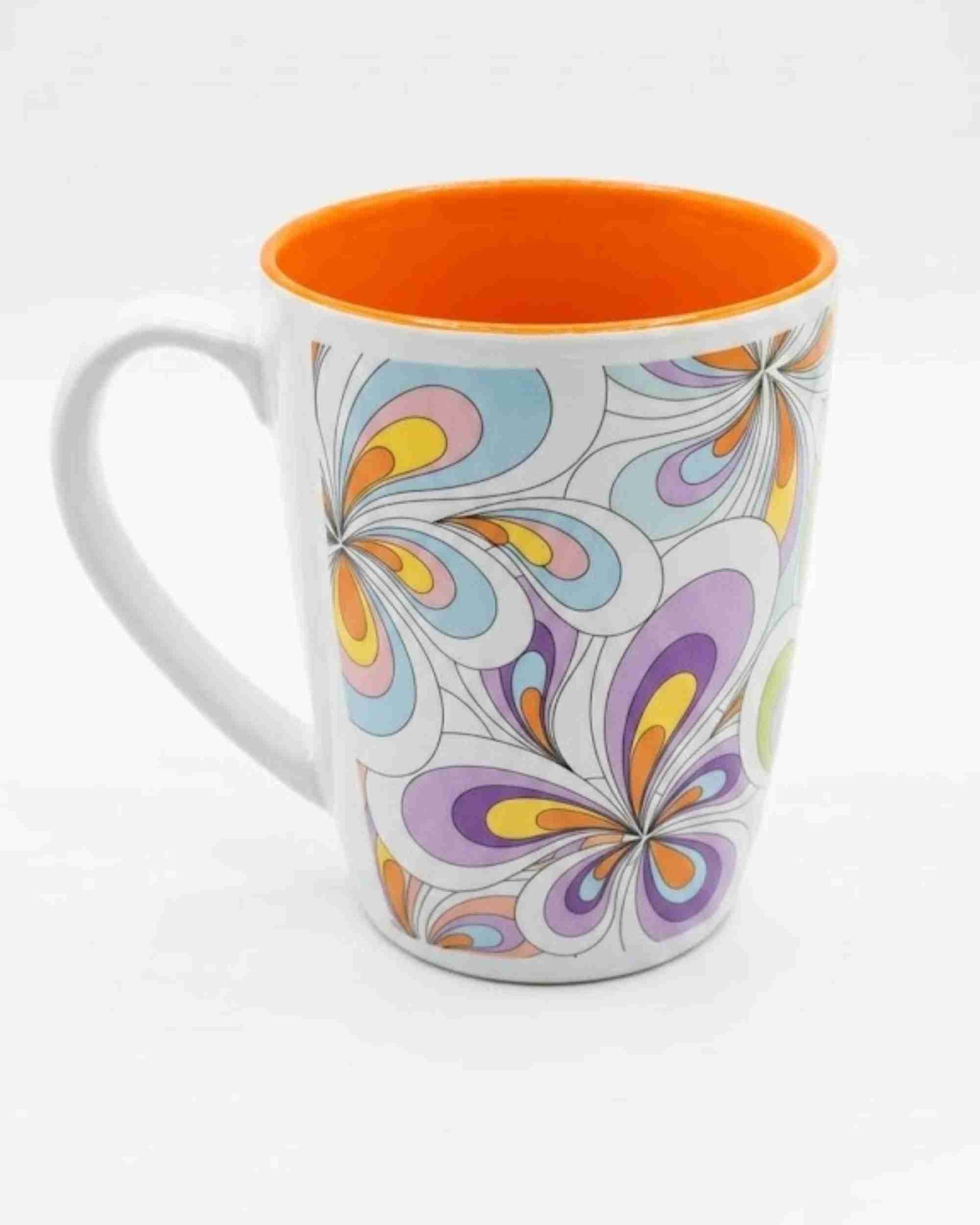 Ceramic coffee mug with handle, orange interior rim, colorful swirl floral pattern