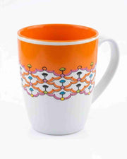Ceramic coffee mug with bright orange interior and floral pattern on front