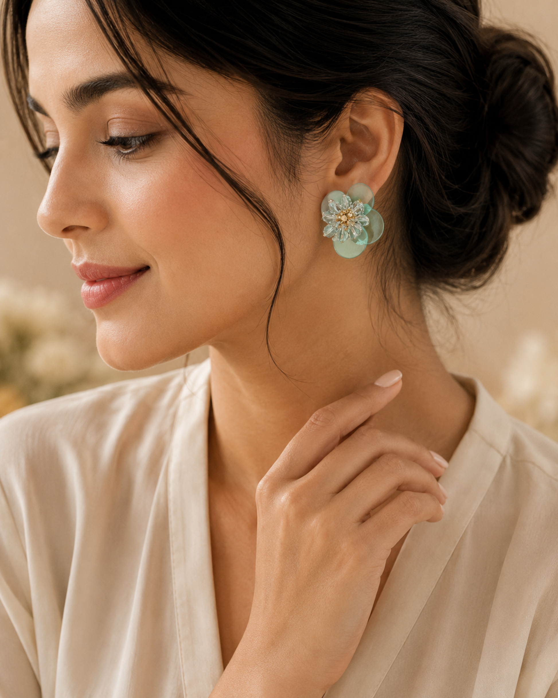 Mint green crystal floral earrings worn on ear, layered translucent petal design