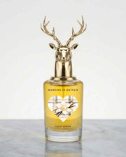 Gold deer-antler eau de parfum bottle with amber glass and floral label