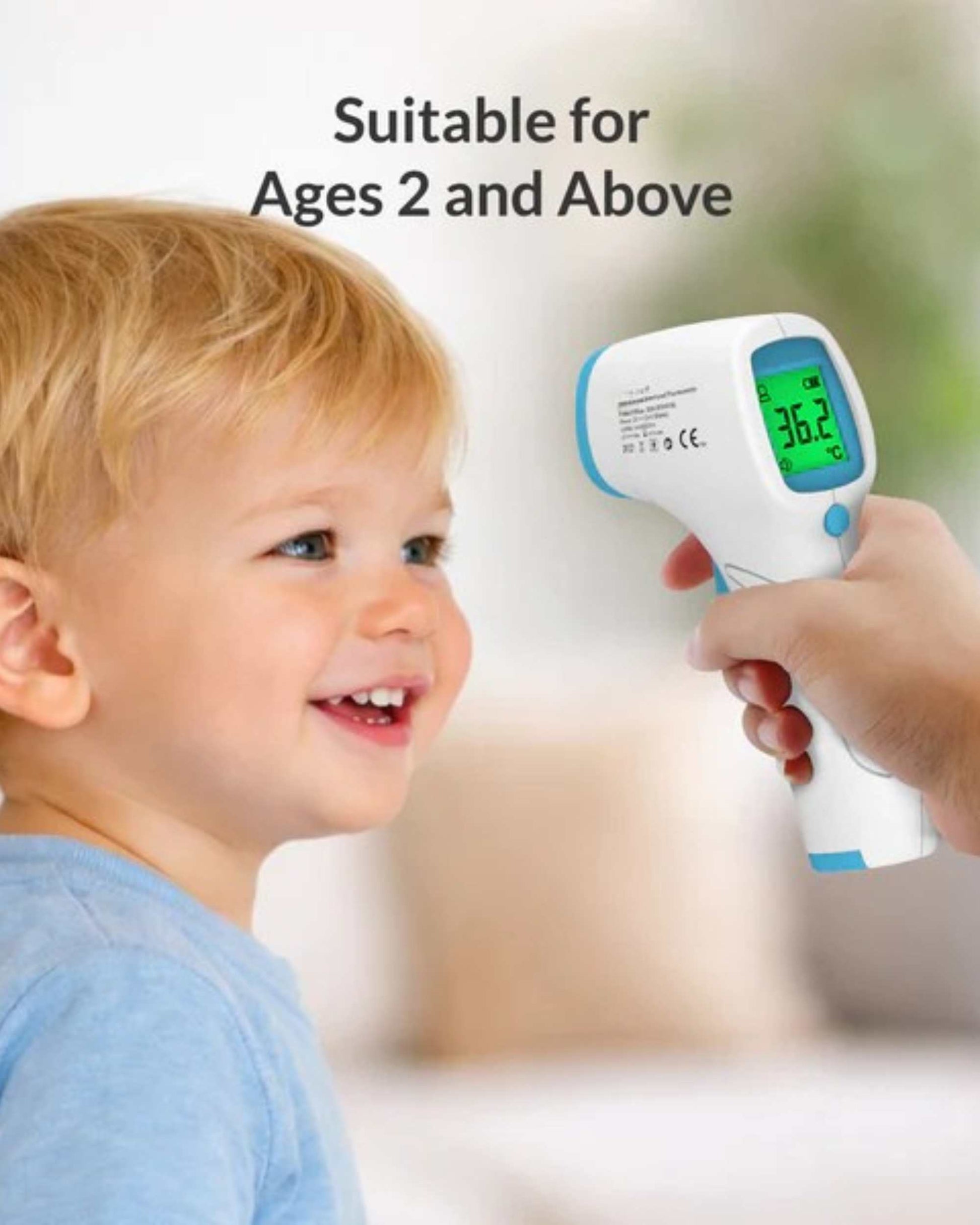 Non-contact infrared thermometer gun held to measure a child’s temperature