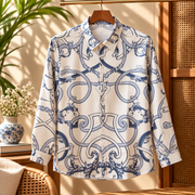 Men's long-sleeve button-up shirt with an ornate blue baroque print on a light base