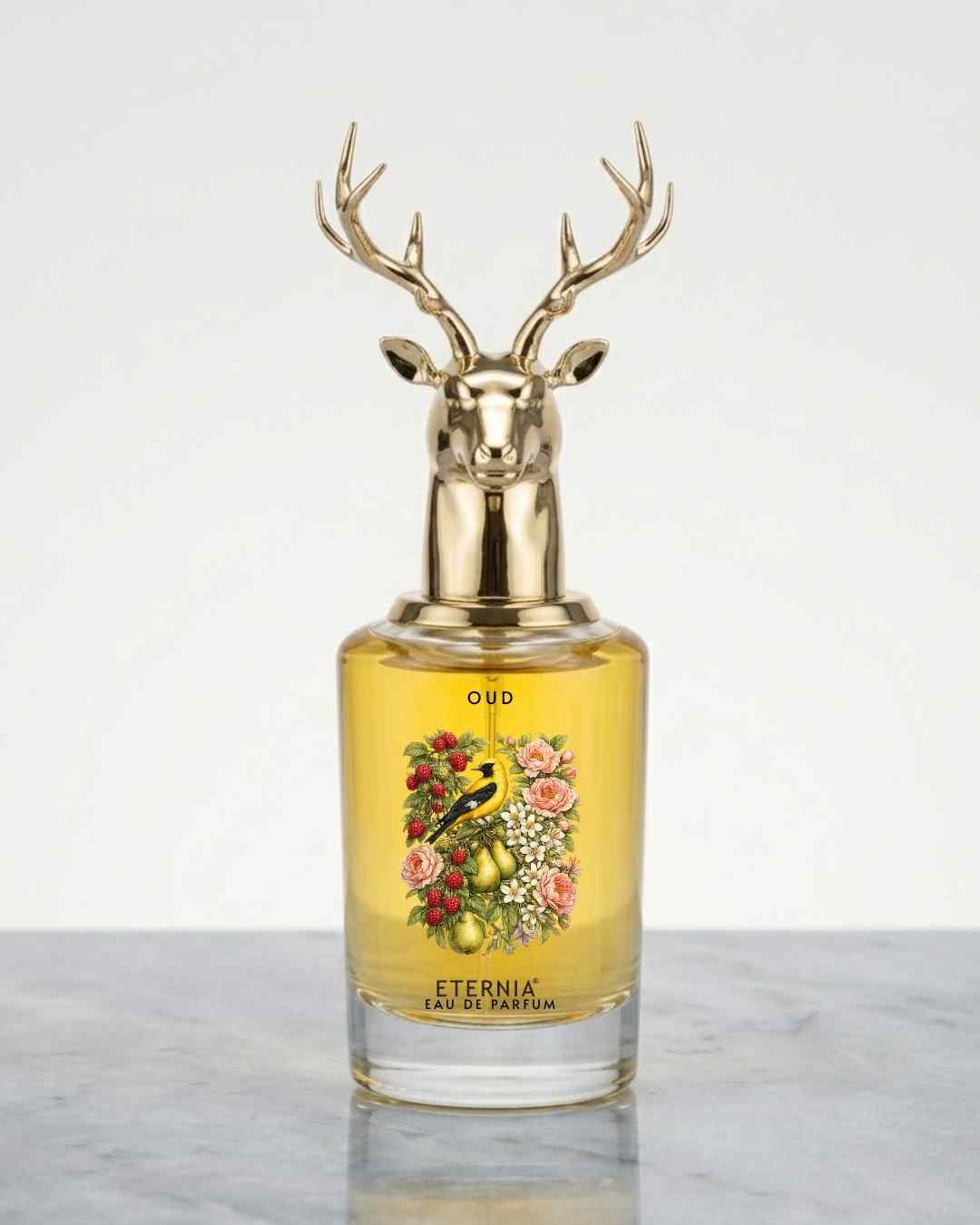 Eternia® oud eau de parfum bottle with gold deer-antler cap and glass body