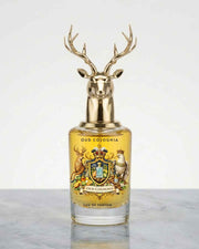 Oud Colonia eau de parfum bottle with gold deer antler cap and amber label