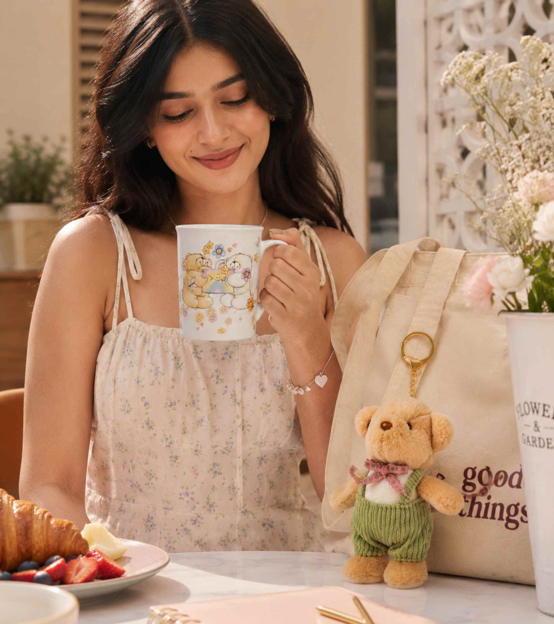 Ceramic coffee mug with cartoon design and plush teddy keychain in green sweater