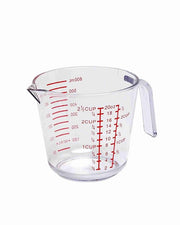 Clear plastic measuring jug with red measurement markings and pouring handle