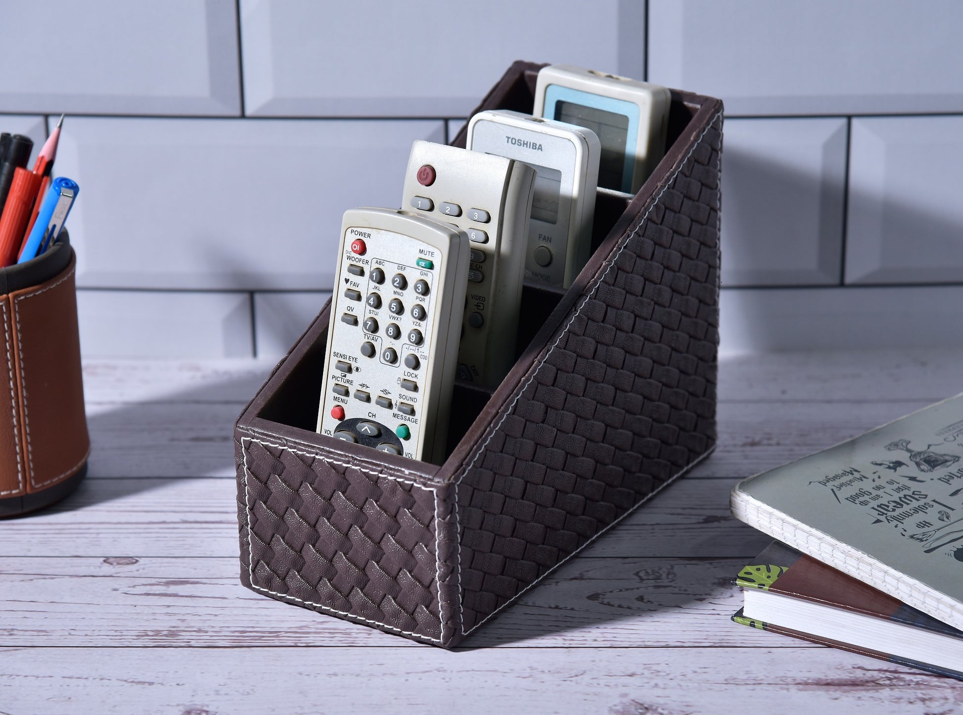 Woven remote holder with 4 compartments, holding two remotes and TV controls