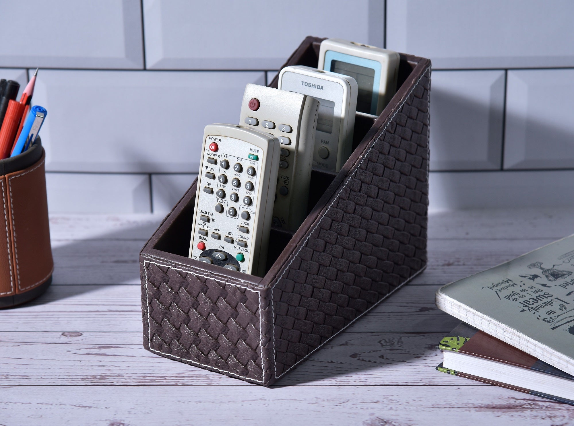 Woven remote holder with 4 compartments, holding two remotes and TV controls