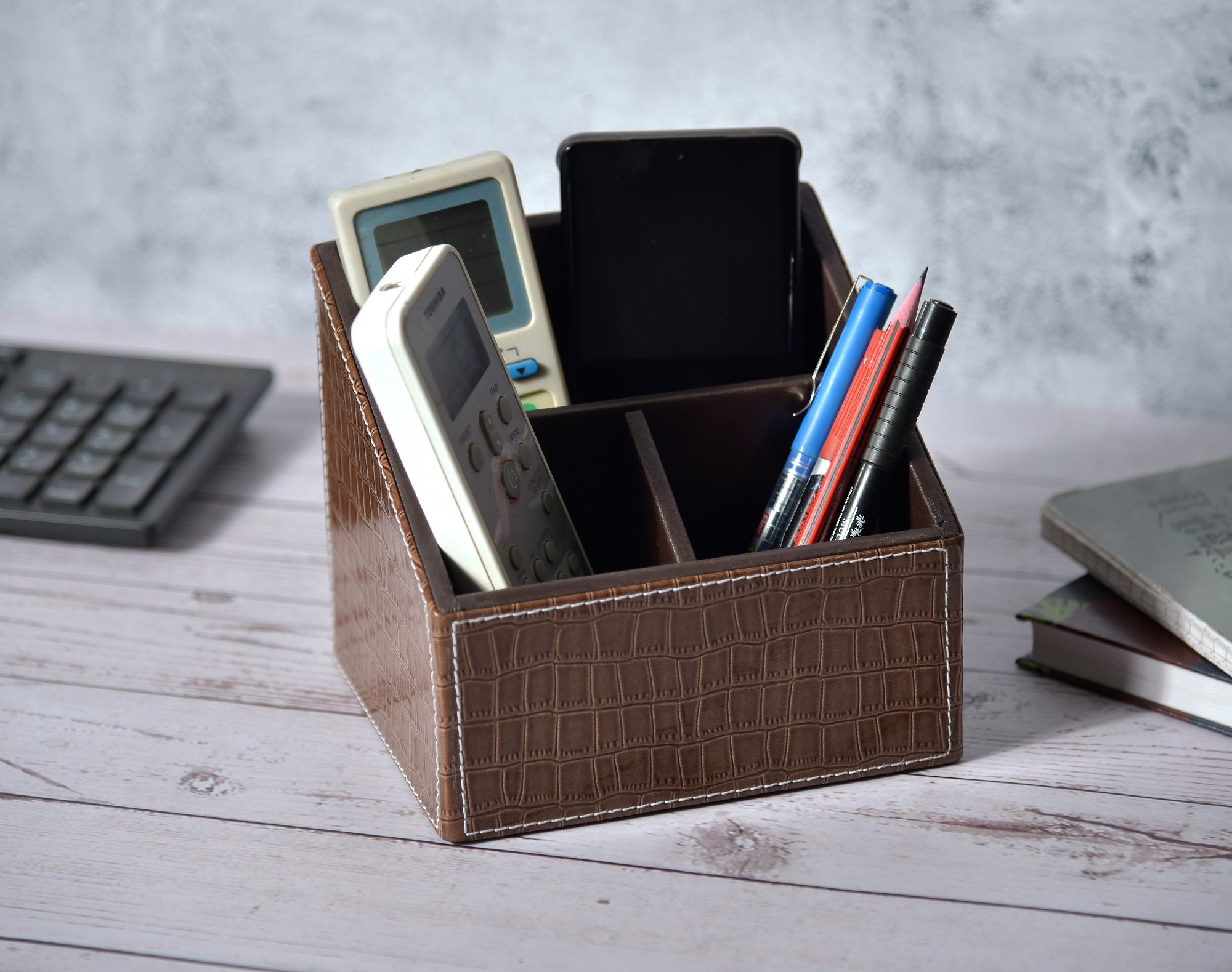 Croc-pattern rectangle remote holder with 3 compartments, brown with dark interior.