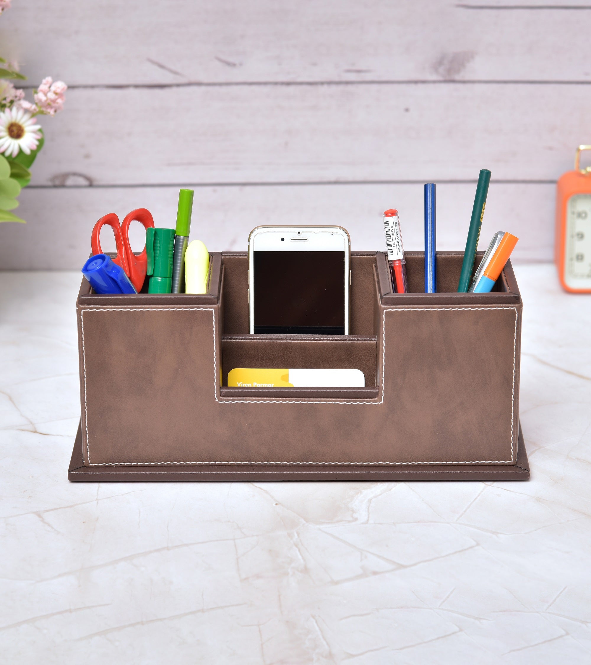 Two-compartment desk organizer holding pens and cards, brown faux leather look with central tray