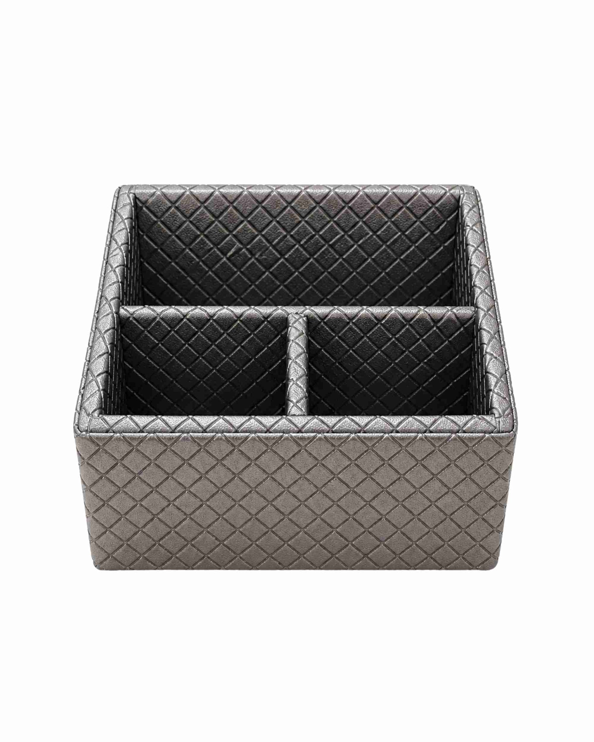 Three-compartment remote holder in metallic silver-gray leatherette with diamond pattern.