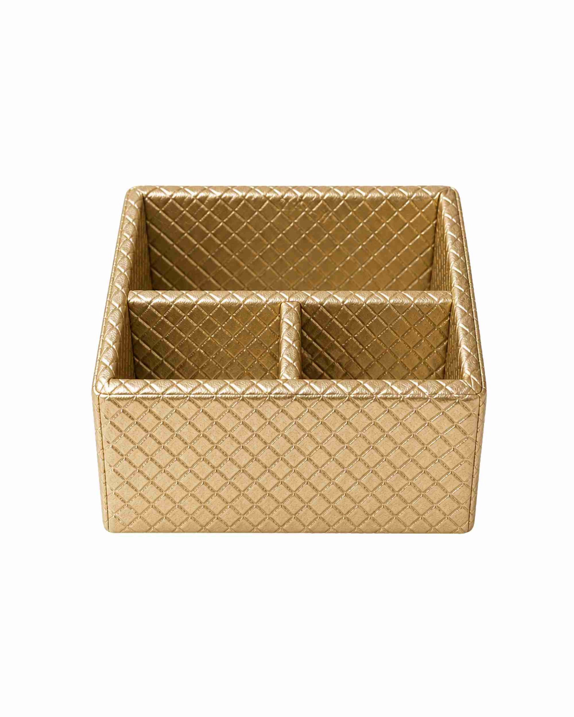 Three-compartment remote holder in metallic gold leatherette with diamond pattern.