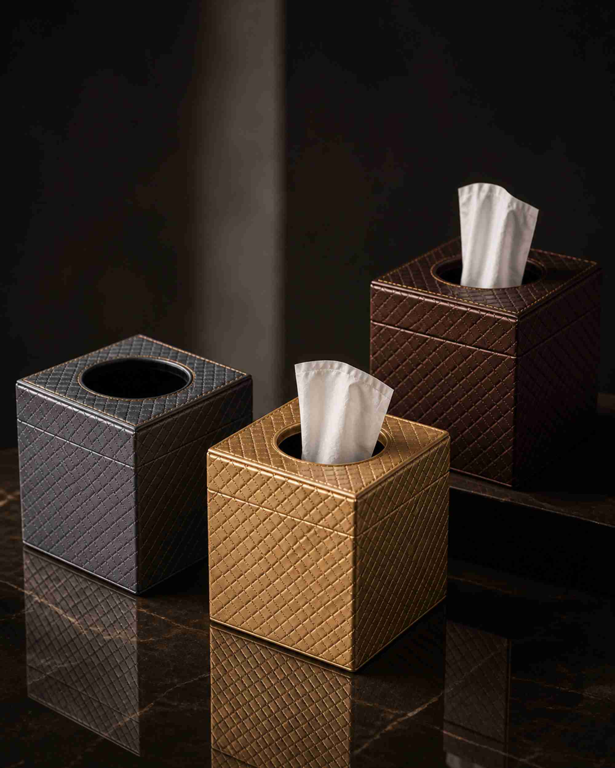 Three metallic leatherette tissue box holders in silver, gold, and bronze