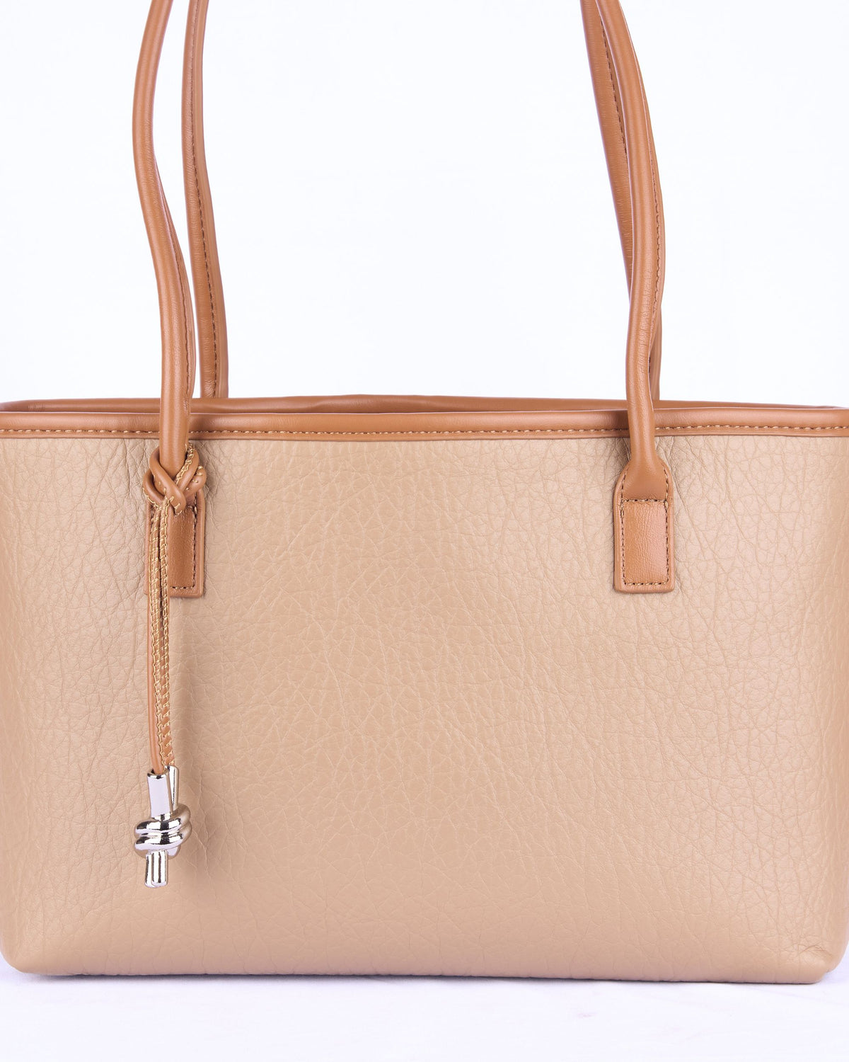 Light brown leather-look handbag detail with hanging tassel cord and front tabs