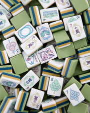 Celadon Mahjong tile set, green and white tiles with blue-yellow stripe and suit symbols