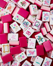 Assorted mahjong tiles: white faces with magenta borders and colorful motifs