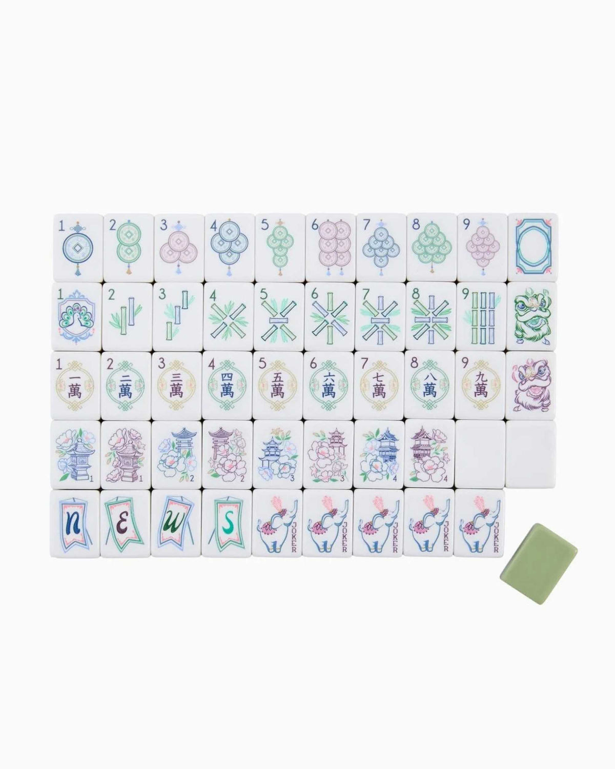 Acrylic mahjong tile set laid out in rows on a card, with one green tile.