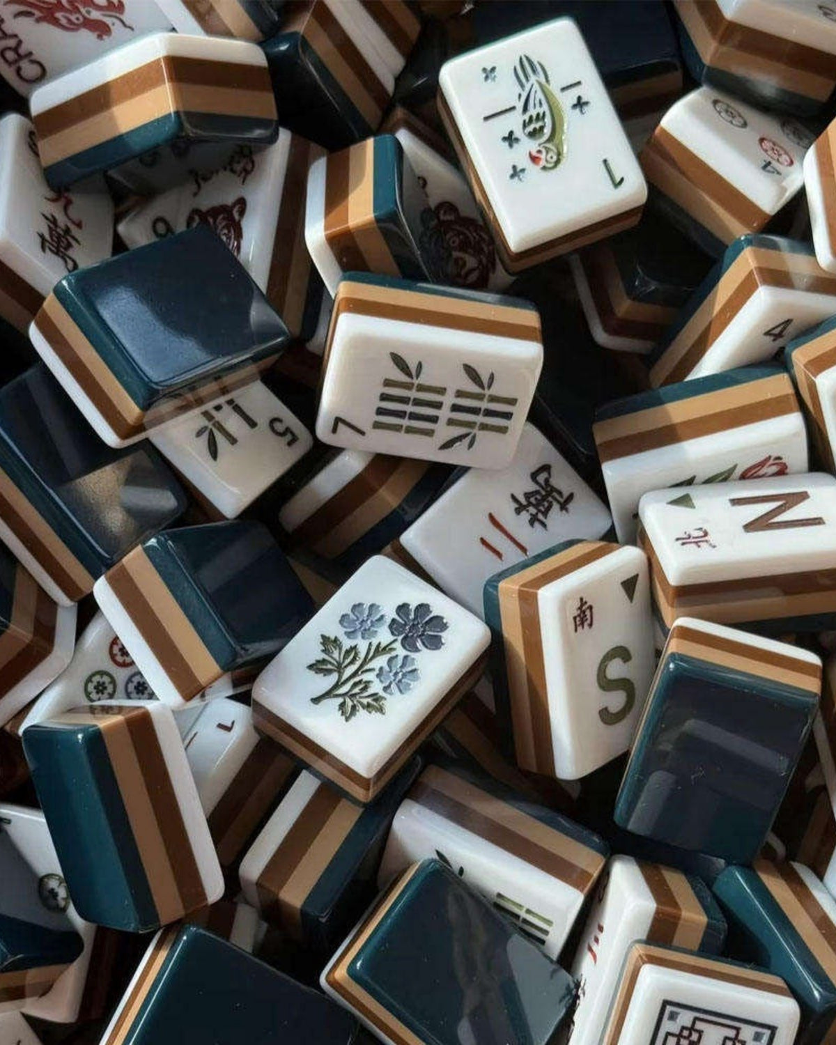 Mixed acrylic mahjong tiles pile with joker and bamboo character faces