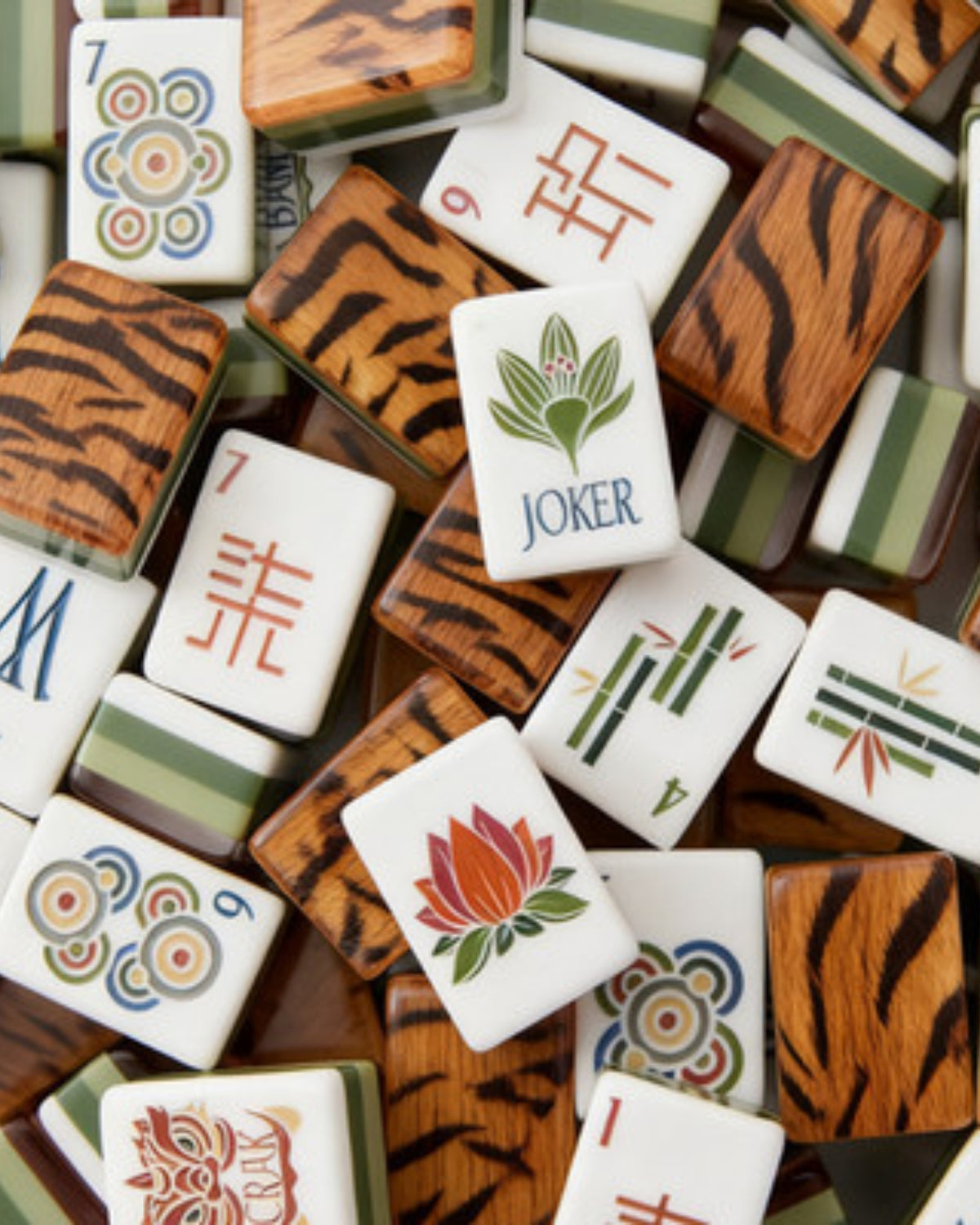 Acrylic mahjong tiles close-up with tiger-pattern backs and joker flower faces