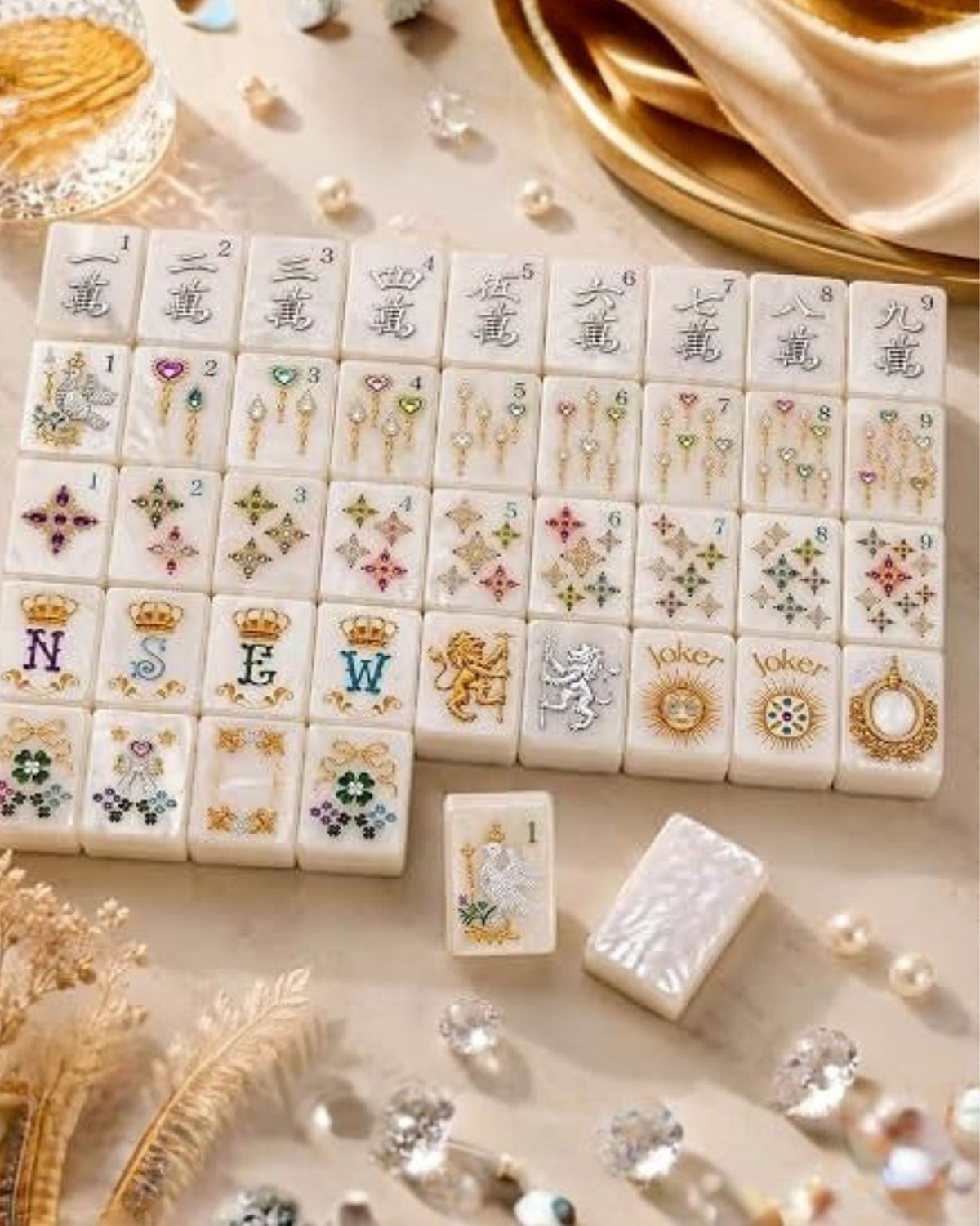 Pearlescent mahjong tiles with Joker tiles and mixed numbers, scattered on a tray