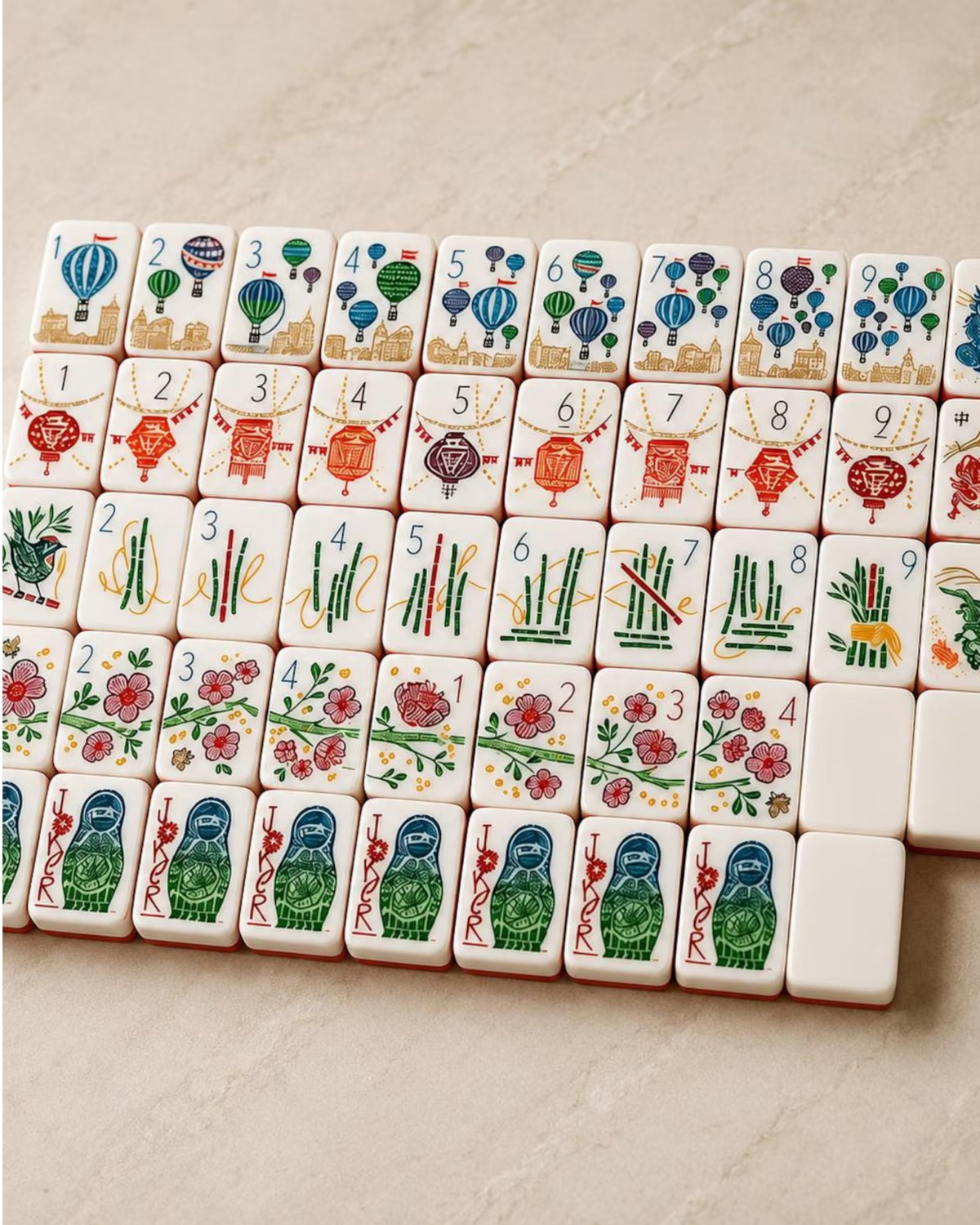 Colorful numbered mahjong tiles with suit icons arranged in rows on white