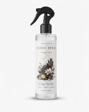 White fabric spray bottle with black trigger nozzle and floral label, front view