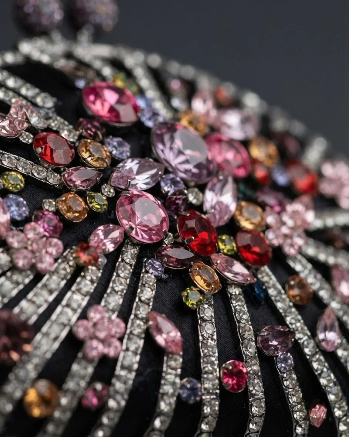 Crystal rhinestone clutch front detail with pink, red, gold and silver gem accents