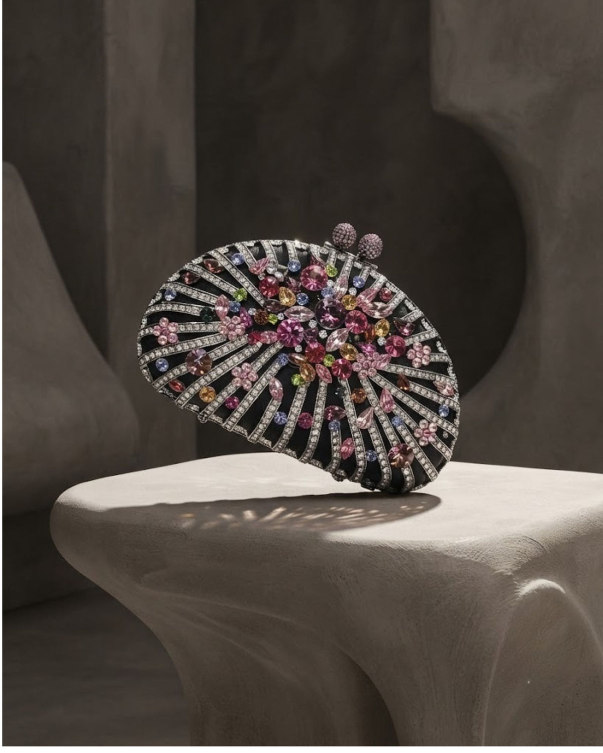Embellished statement clutch with black base and multicolour rhinestone circular design