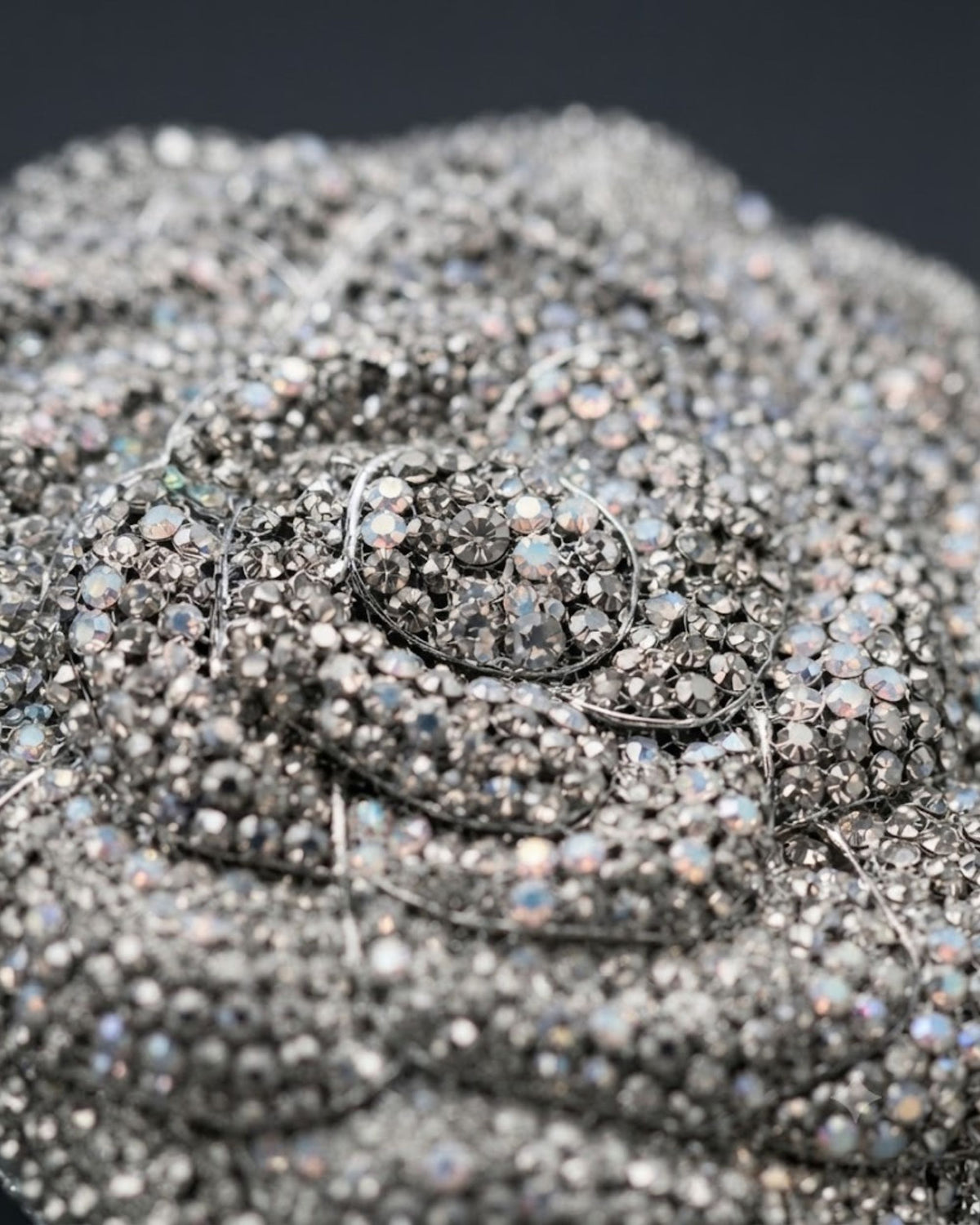 Silver rhinestone handle clutch close-up with crystal strands and clasp