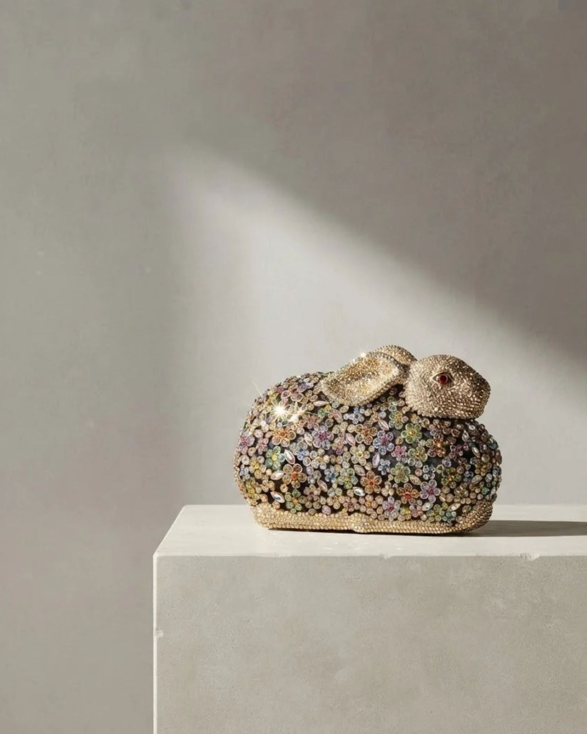 Gold crystal rabbit-shaped statement clutch with multicolour rhinestone embellishment