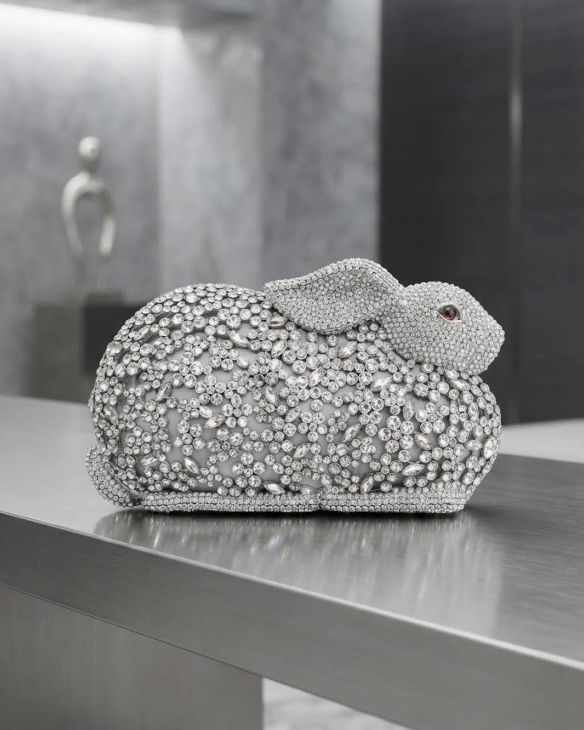 Silver crystal rabbit-shaped clutch on pedestal with full rhinestone embellishment