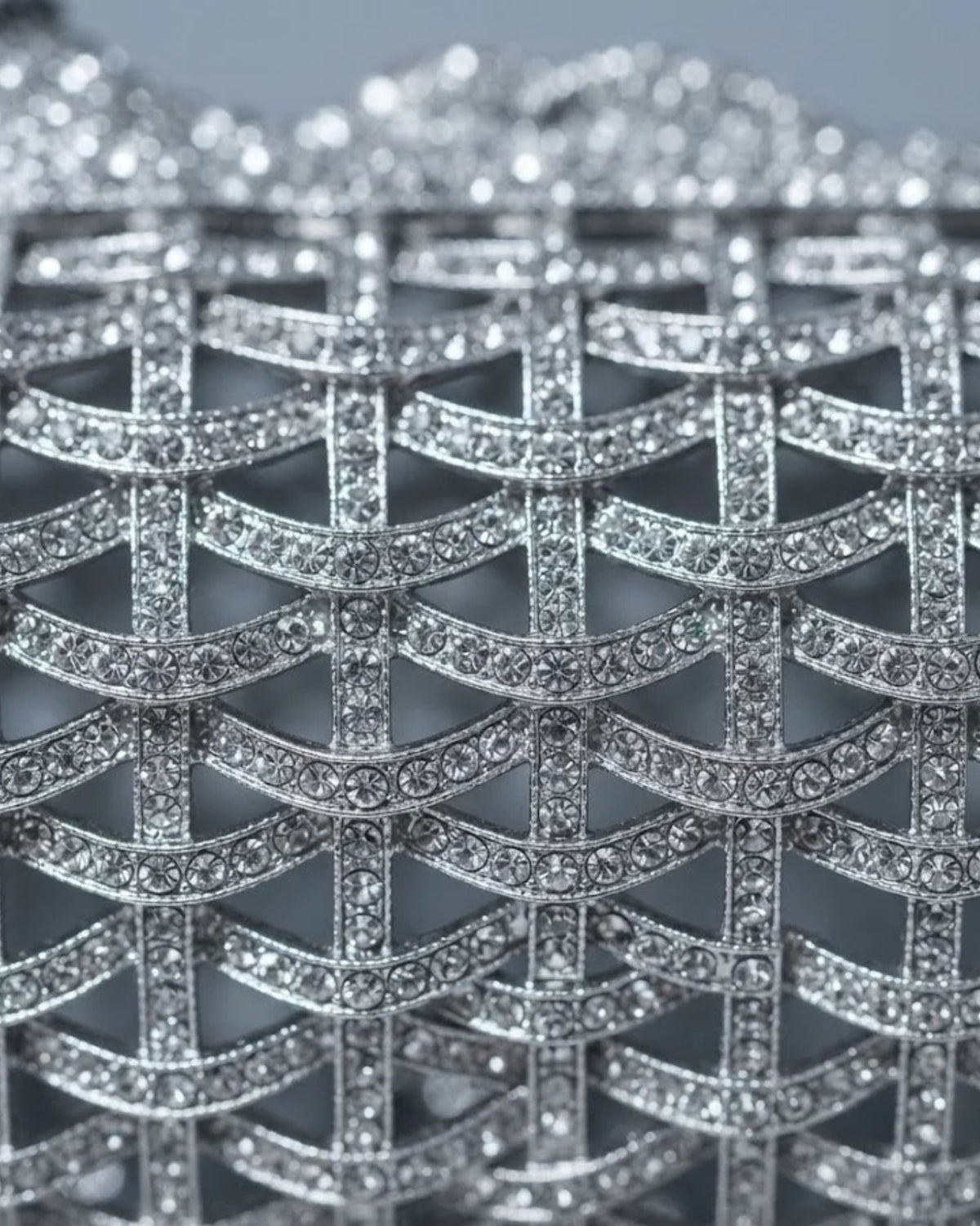Silver rhinestone lattice embellishment detail on dog-shaped clutch