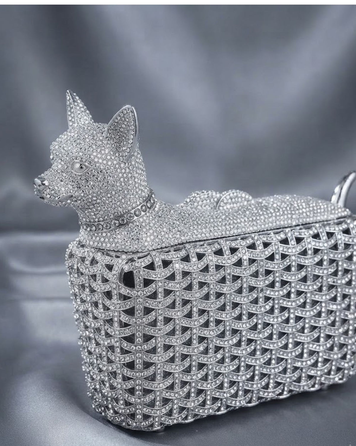 Silver rhinestone dog clutch with textured crystal lattice and curved handle